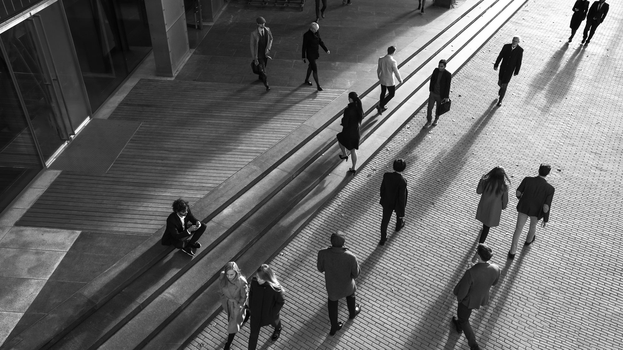 Aerial view of people crossing a city plaza