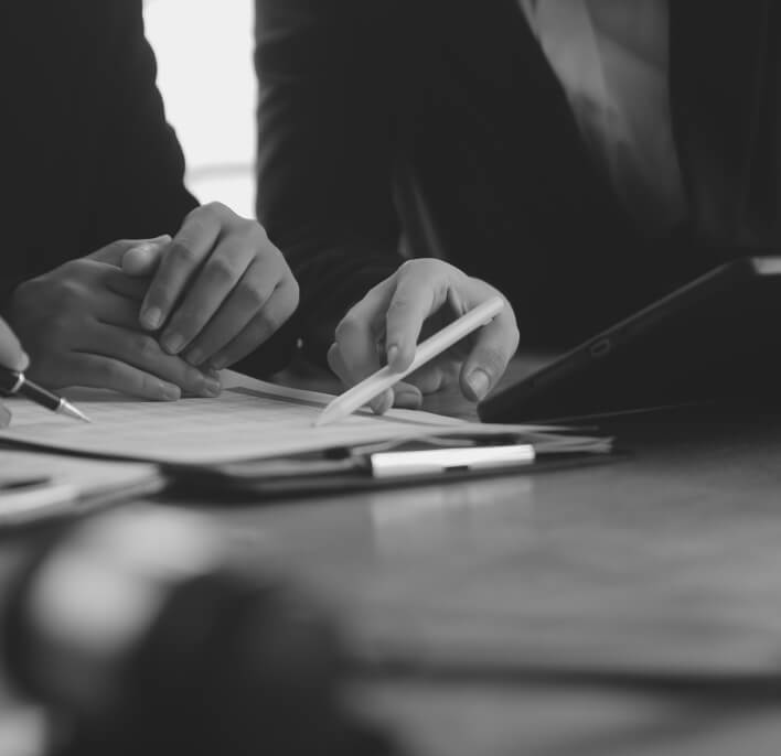 Hands reviewing a document with a pen