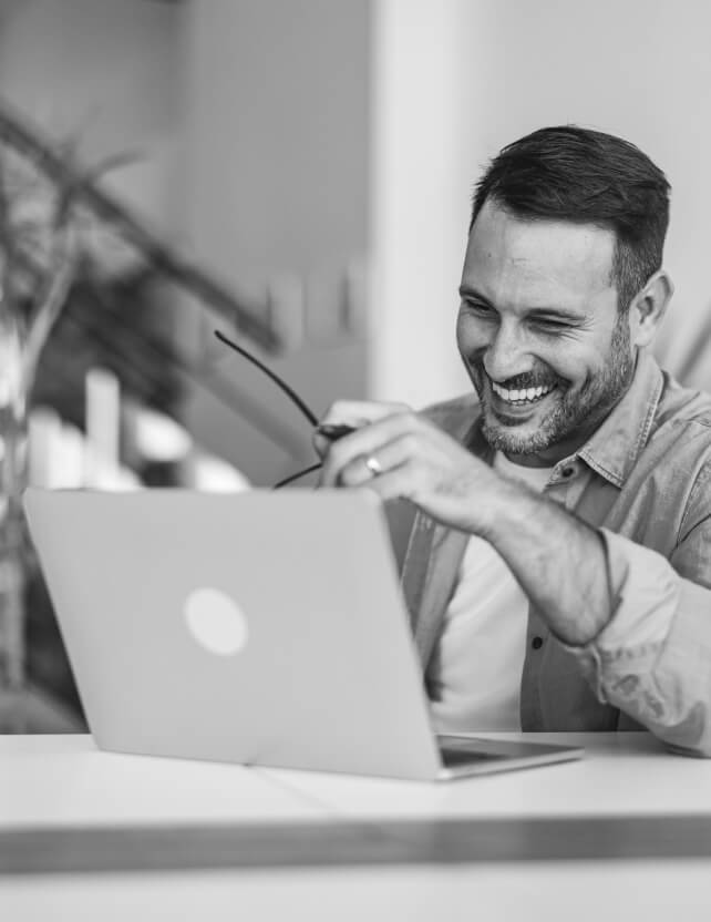 Smiling professional working on a laptop