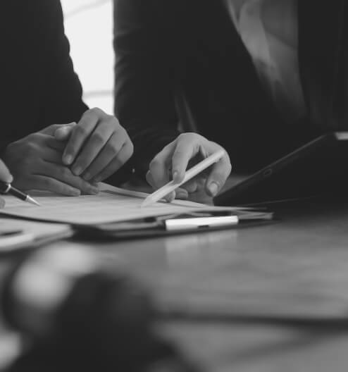 Two people reviewing a document with a stylus