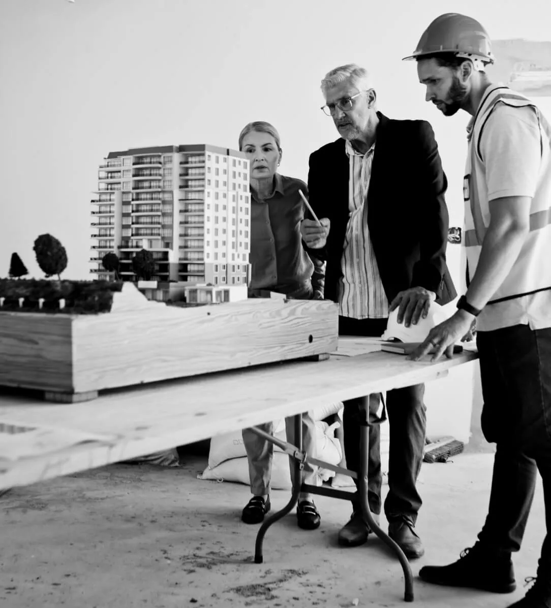 Advisers reviewing a scale model of a building development on site