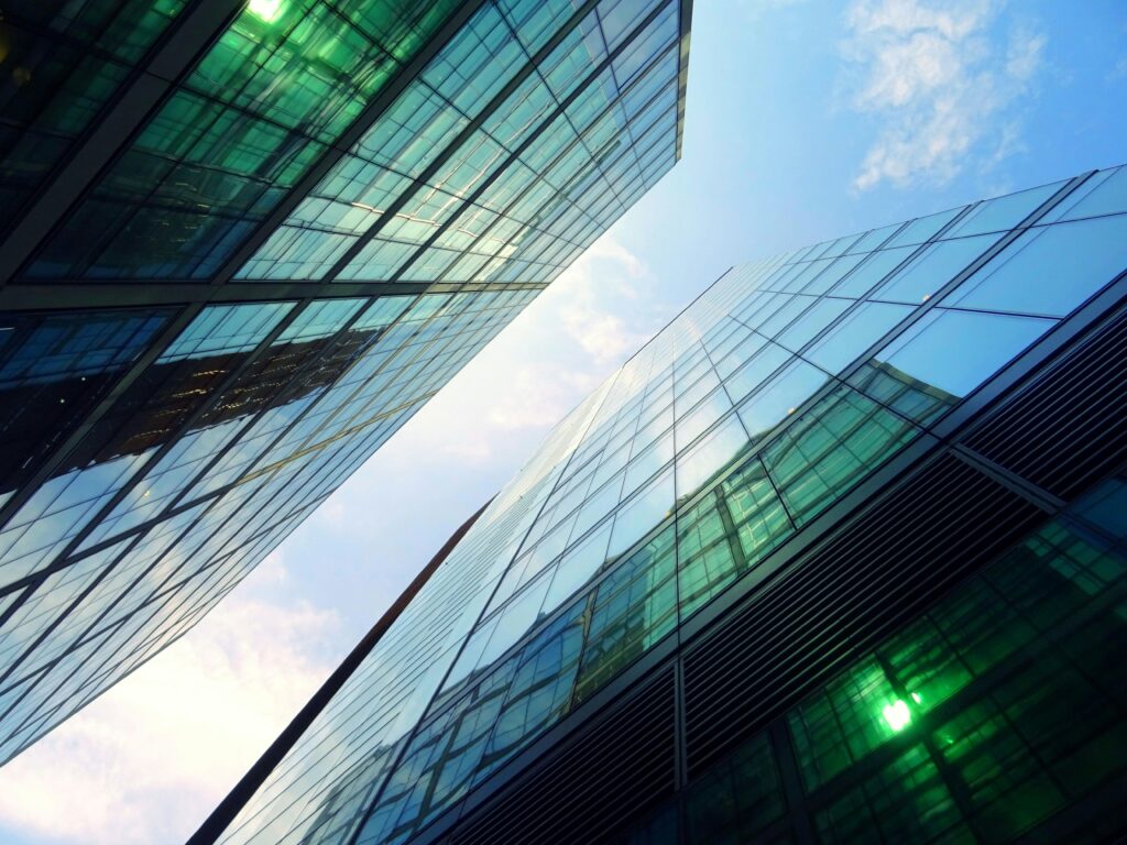 Looking up at glass office towers against the sky