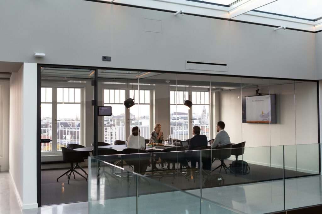 Meeting room behind a glass wall in an open office