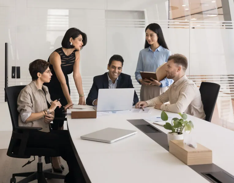 Team meeting around a boardroom table in a bright office